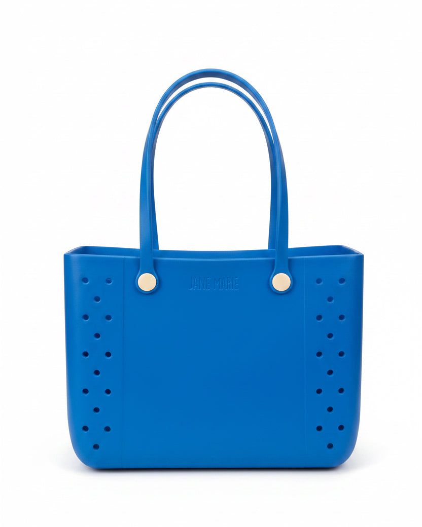 Large blue Jane Marie Multi Purpose Tote with rubber handle and white button details, available in large size.