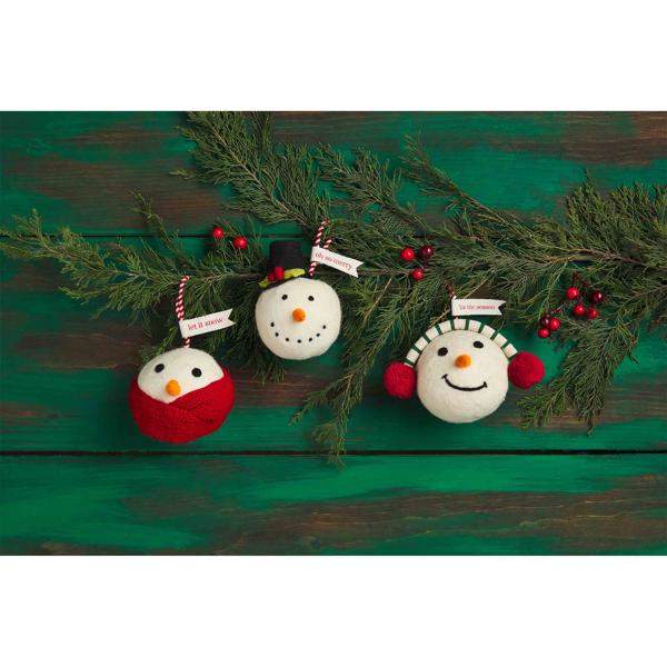 Three felted wool Snowball Ornaments with tags reading “let it snow,” “oh so merry,” and “’tis the season.”