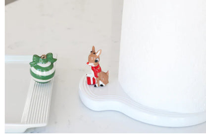 Paper Towel Holder Pinstripes: Festive reindeer figure with red scarf, holding a gift; unique wave shape design. Available size: One size.

Nora Fleming Melamine Tray: Adorned with green and white striped ornament, finished with a gold bow. Available size: One size.