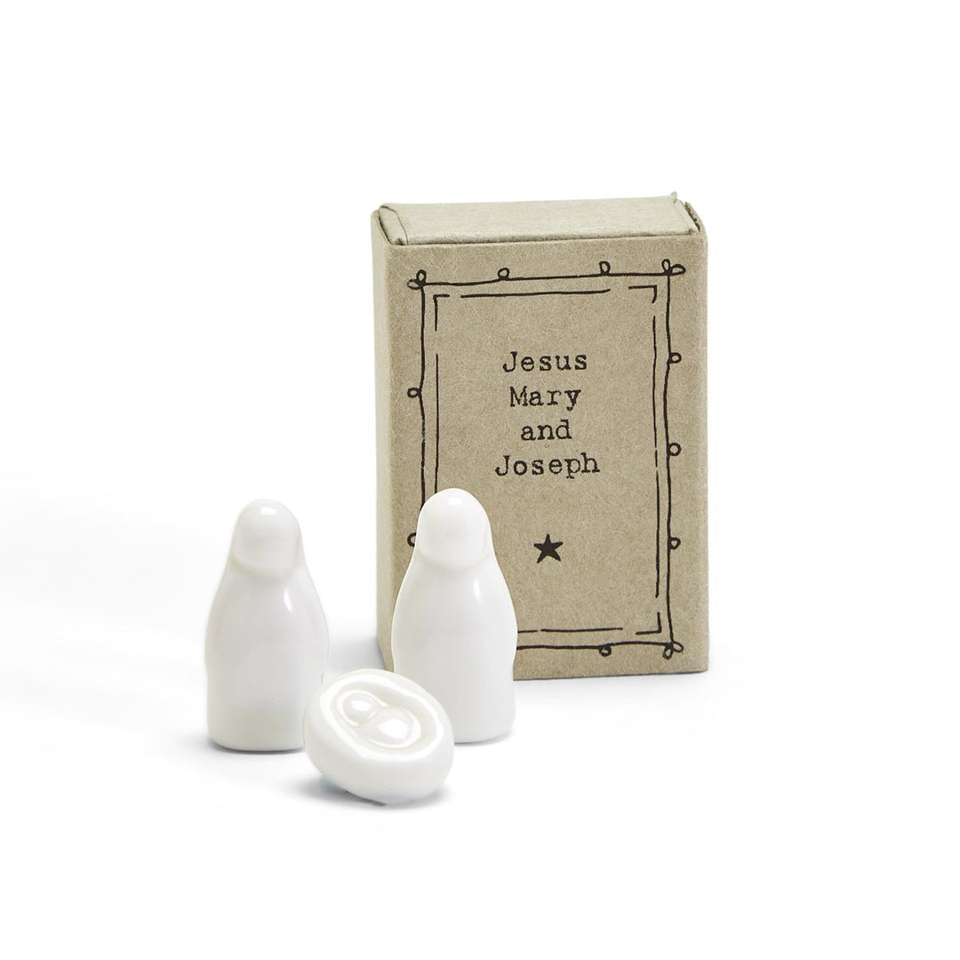 Miniature porcelain Jesus, Mary and Joseph figurines in a labeled matchbox.