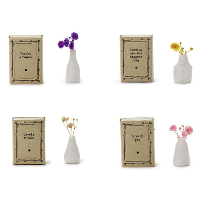 The Lovely Matchbox Vase with Flowers features four small porcelain vases with dried flower arrangements, each in kraft paper boxes. Messages include: "Thanks a bunch," "Sending you the biggest hug," "Lovely friend," and "Lovely you.