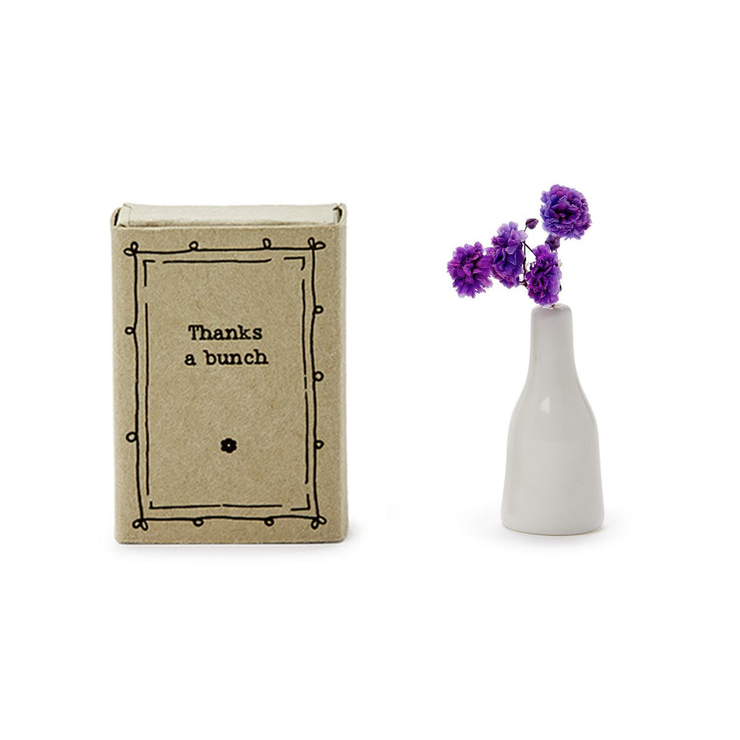 The Lovely Matchbox Vase with Flowers includes a white porcelain vase with purple dried flowers and a "Thanks a bunch" design. Size not specified.