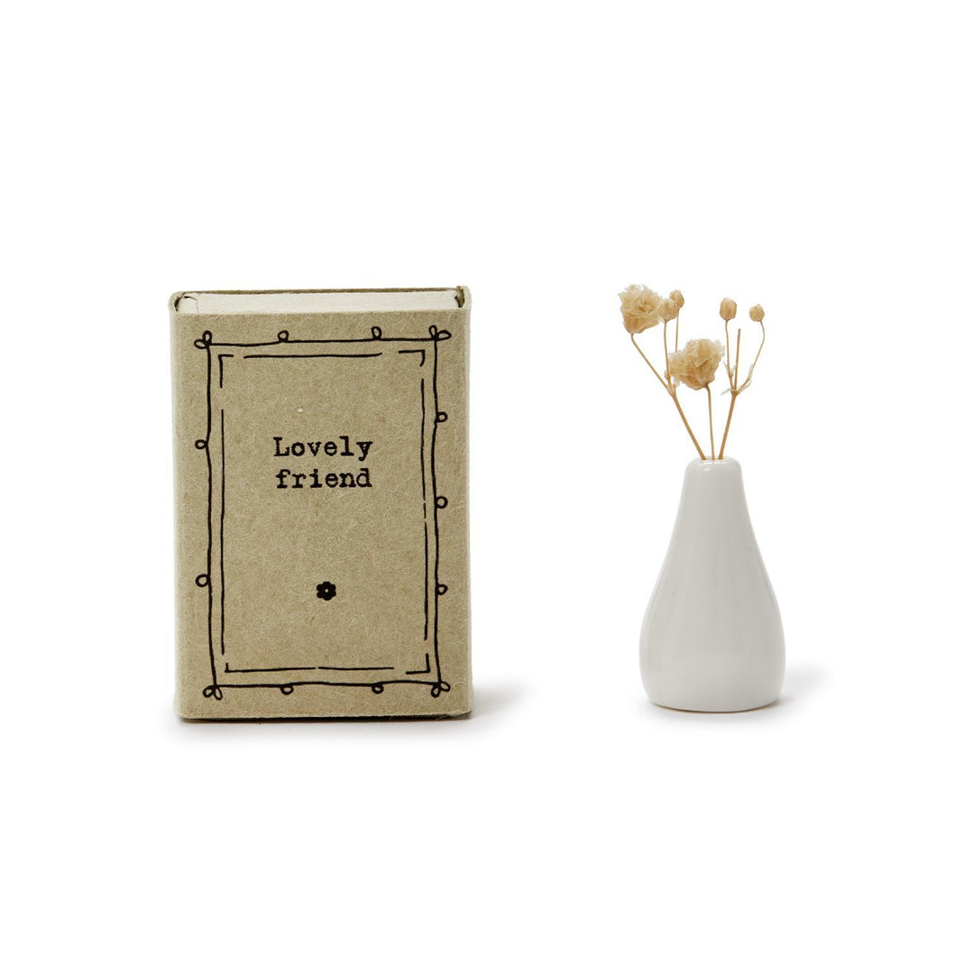 The Lovely Matchbox Vase with Flowers is a small, charming cardboard box containing a mini vase and dried flowers. Available size: Small.