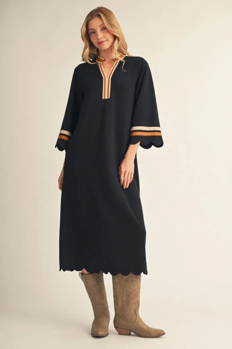 Black Solid Midi Dress With Scalloped Edges features a relaxed silhouette, scalloped edges, and striped trim on the neckline and sleeves. Available in sizes XS-XL.