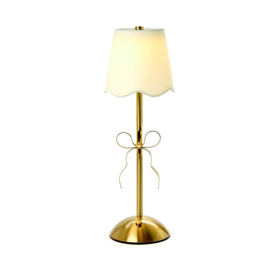 LED Cordless Gold Bow Table Lamp with gold bow accent, round base, slim stand, white scalloped shade. Sizes: Small, Large.