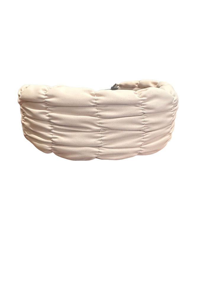 Padded headband wrapped in light beige ruched fabric. Available sizes: S, M, L.
