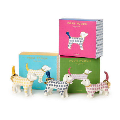 Ceramic dog-shaped ring holder with decorative prints and colored tails and noses; available in three assorted colors. Sizes available: standard.