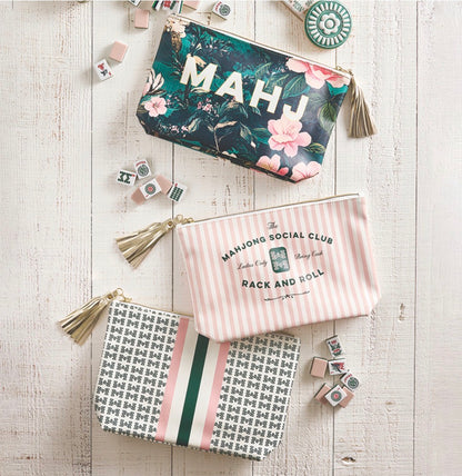 Set of three Mahjong Oil Cloth Pouches with tassels in floral, striped, and geometric patterns. Available in small, medium, and large sizes.
