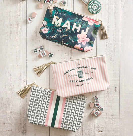 Set of three Mahjong Oil Cloth Pouches with tassels in floral, striped, and geometric patterns. Available in small, medium, and large sizes.