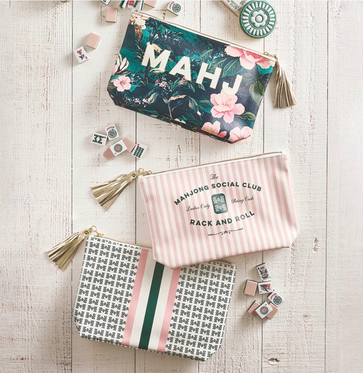Set of three Mahjong Oil Cloth Pouches with tassels in floral, striped, and geometric patterns. Available in small, medium, and large sizes.