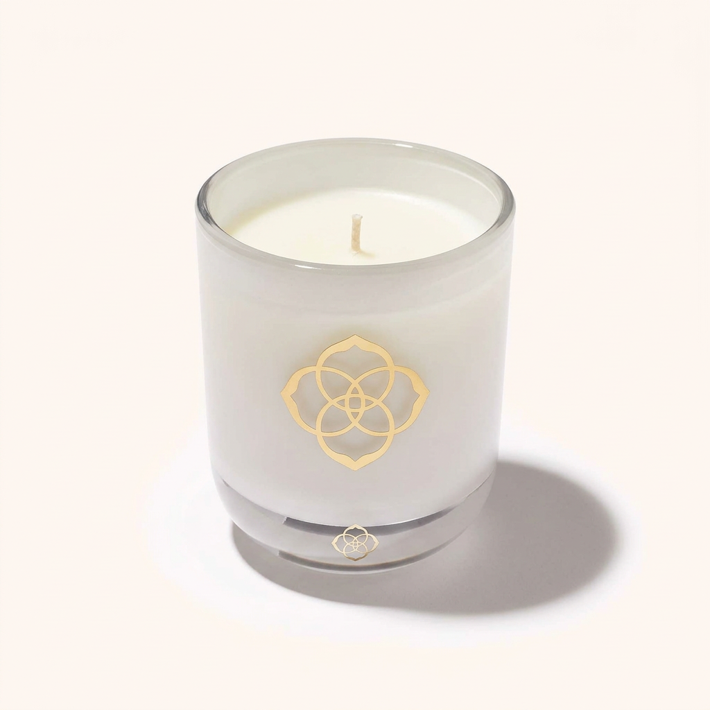 Kendra Scott Rose Quartz 8 oz candle in white glass vessel with gold logo.
