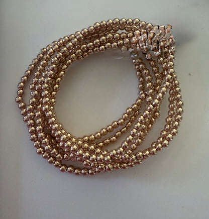 Beaded Stretch Bracelet with shiny round gold-colored beads, coiled multi-strand style. Available in small, medium, large.