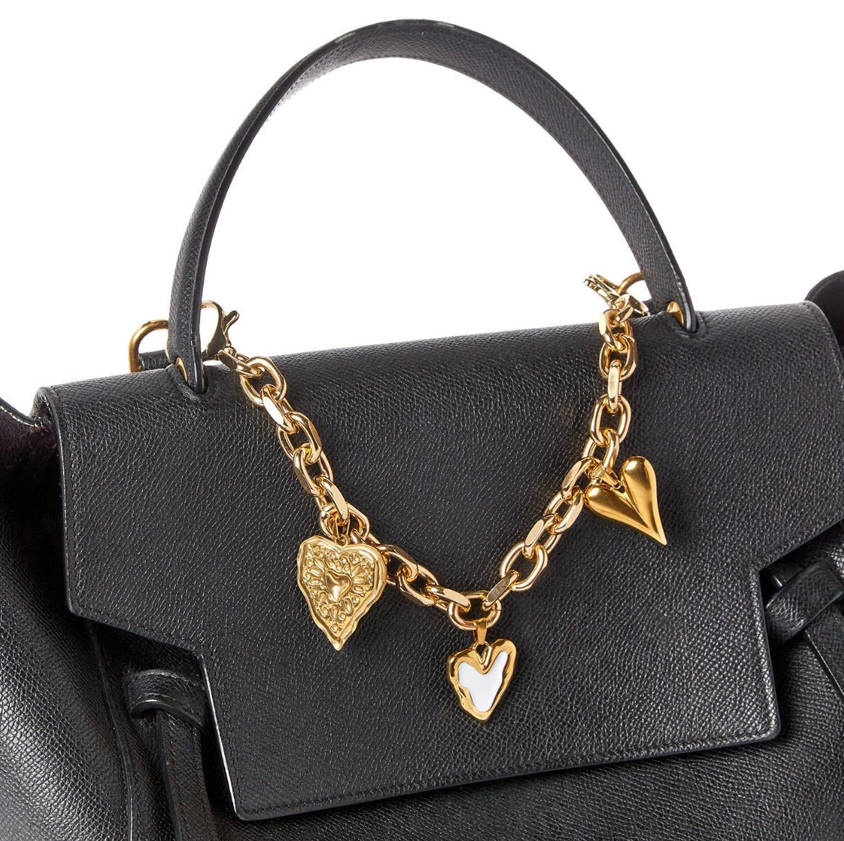 Charmed Life Chain Bag Charms: gold chain with three charms—gold heart, white heart, gold lion head heart. Available in small and large sizes.
