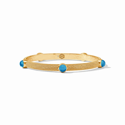 Gold textured bangle with four round turquoise stones in 24K gold plate. Sizes: S, M, L.