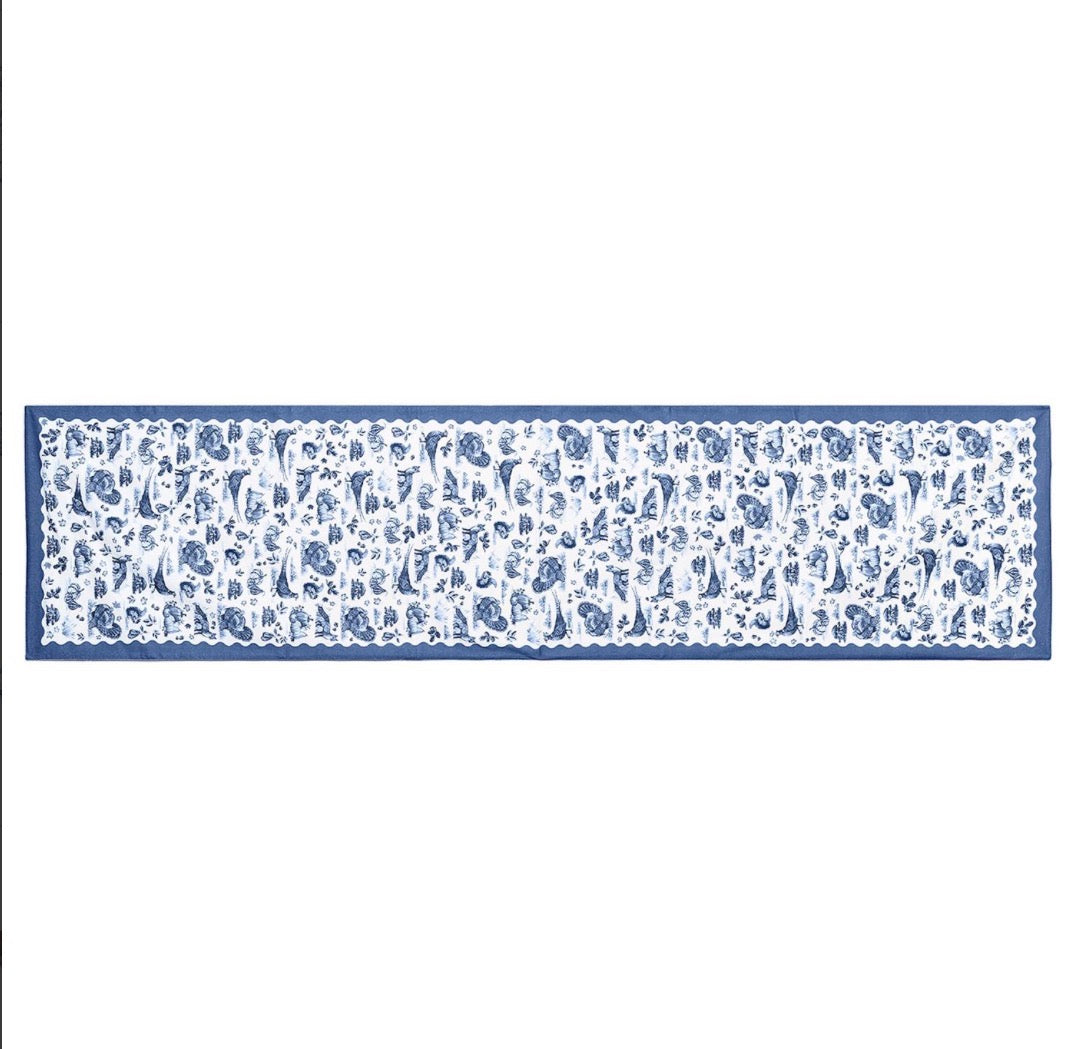 Long, rectangular table runner with a blue and white floral toile pattern and solid blue border; available in multiple sizes.