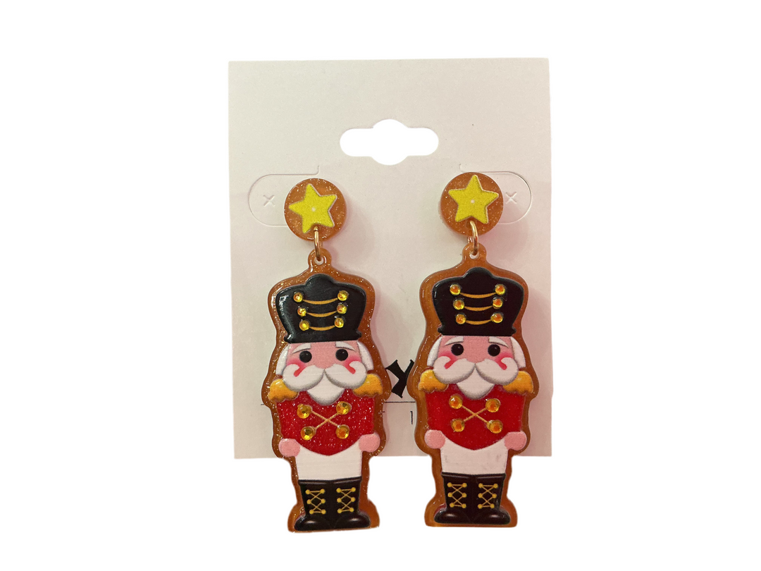 Nutcracker dangle ornament earrings with yellow star studs. Available sizes not specified.
