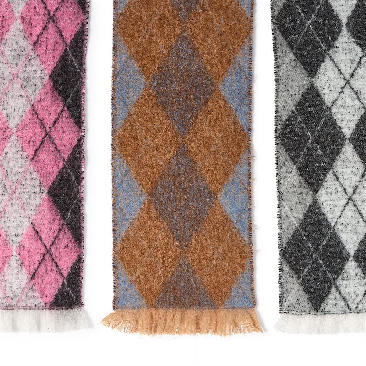 Classic Argyle Scarf with timeless diamond patterns in pink and black, brown and blue, or gray and black. Cozy with fringed edges. Available in multiple sizes.
