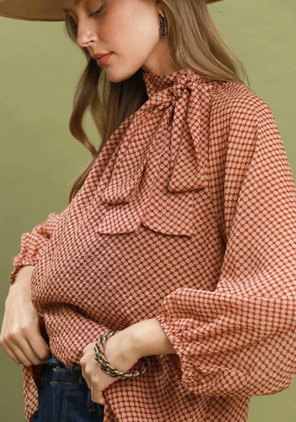 Dottie Tie Top: polka dot blouse with balloon sleeves and tie neck bow, available in sizes XS–XL.