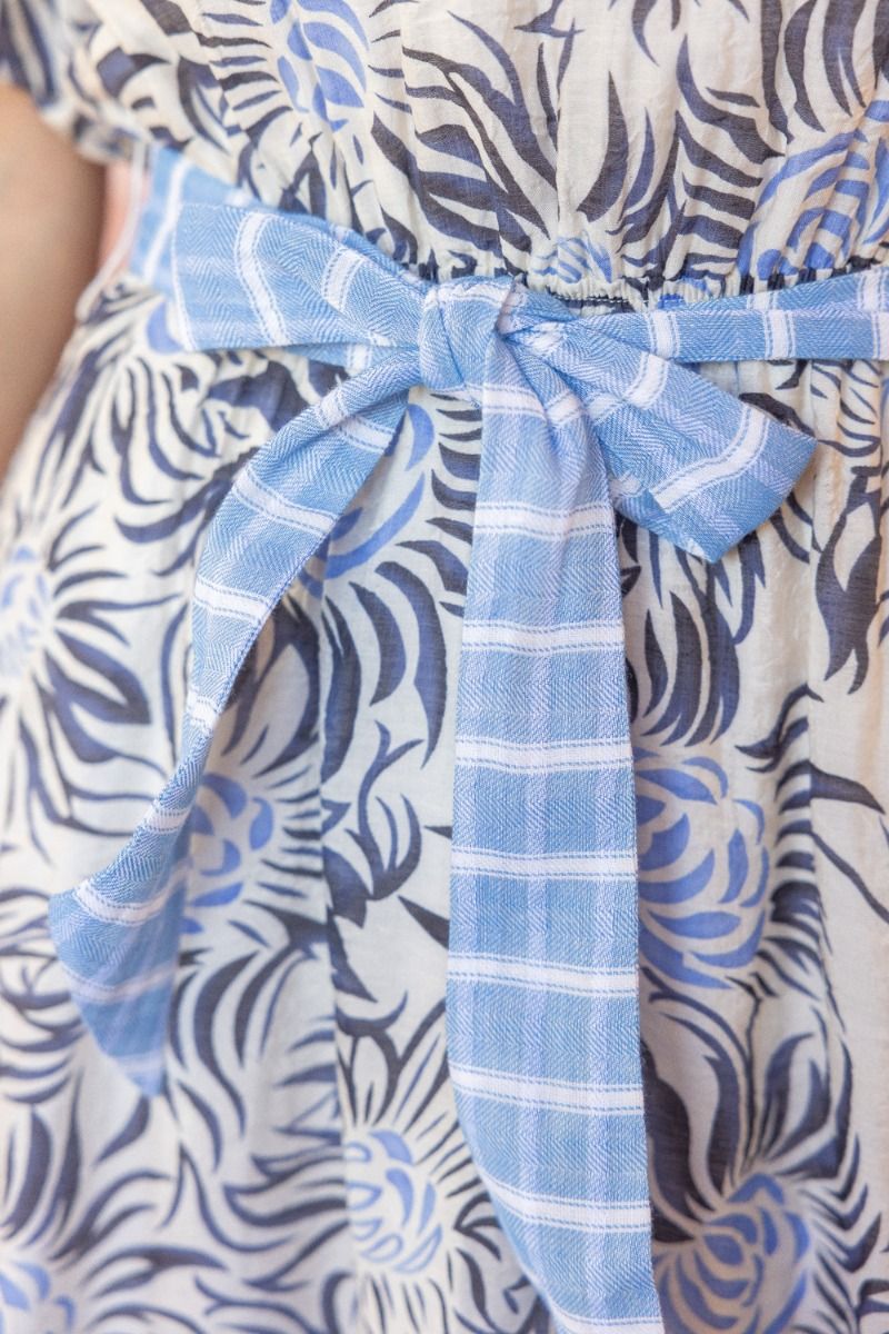 Sadie Dress: blue and white floral print, blue plaid waist tie. Available in sizes XS-XL.