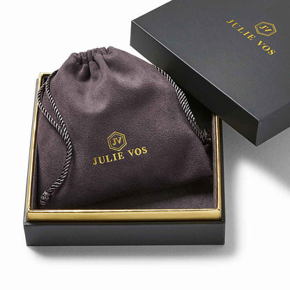 A black jewelry box with gold trim, partially opened to reveal a black drawstring pouch featuring “JULIE VOS” and a gold logo; the box lid displays matching text and logo. Available in sizes Small, Medium, and Large.