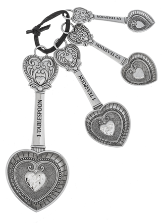 Set of four ornate metal heart measuring spoons (1 Tbsp, 1 tsp, 1/2 tsp, 1/4 tsp), linked by a ring.