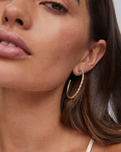 Veronica Hoop Earrings by Kendra Scott: large gold hoops with iridescent crystals. Available in medium and large sizes.
