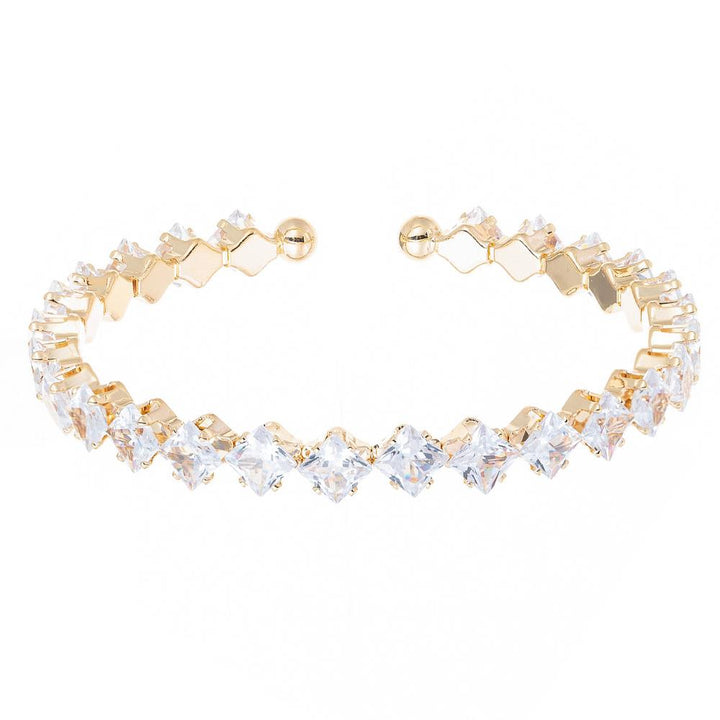 Silver and gold open cuff bracelet with round clear stones in prong settings. Available sizes: S, M, L.