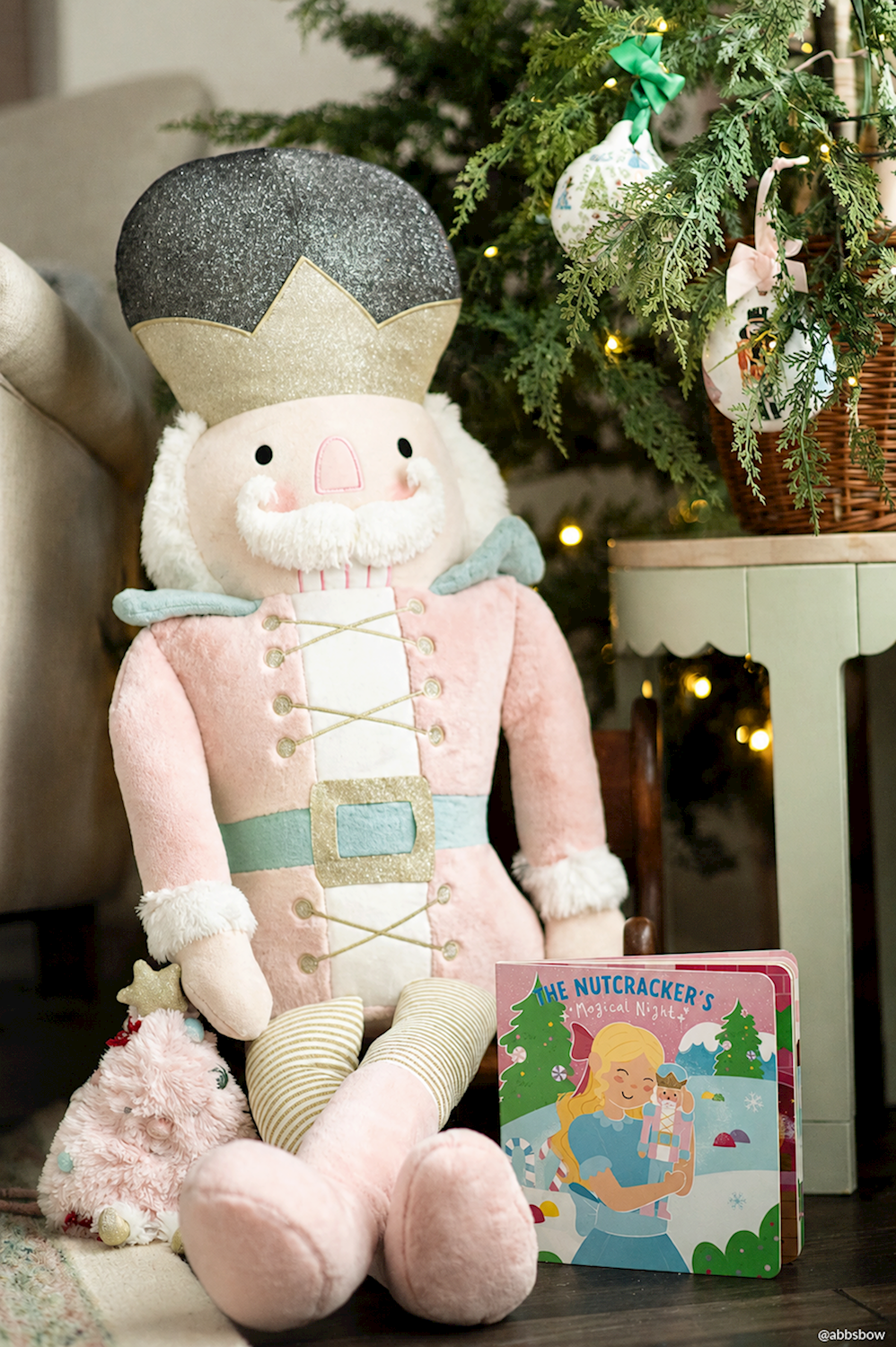 Christmas Nutcracker plush purse in a pink uniform and grey hat.