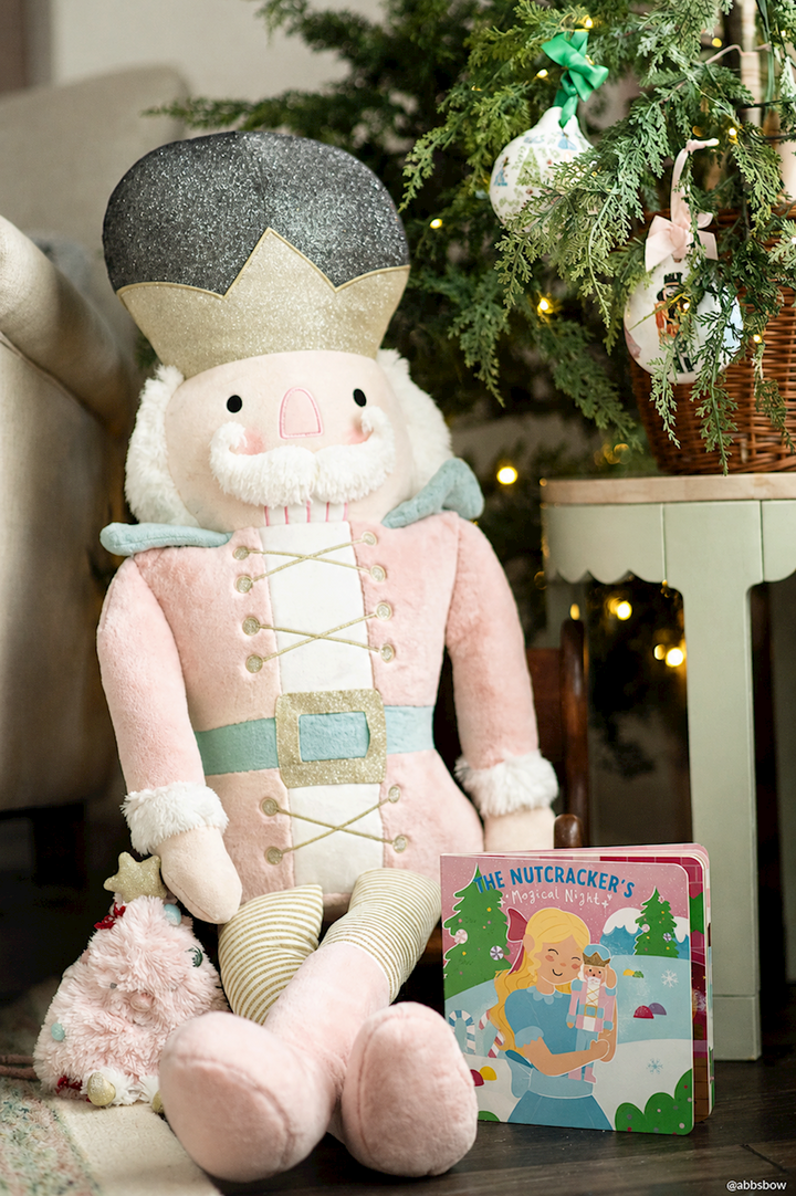 Christmas Nutcracker plush purse in a pink uniform and grey hat.
