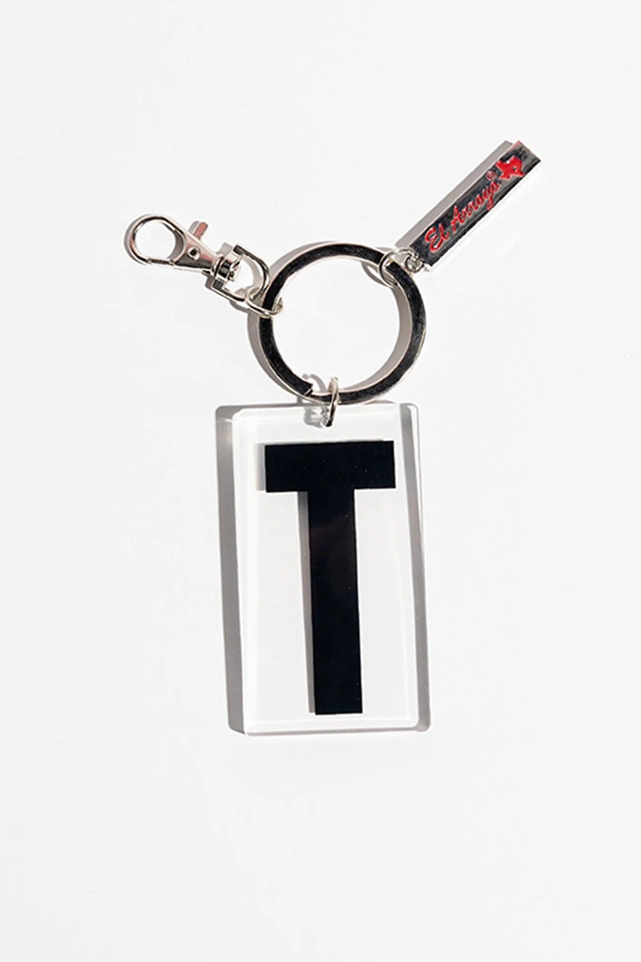 Rectangular acrylic keychain with bold black "T," clear case, metal ring, red text tag, bull silhouette. Sizes available.