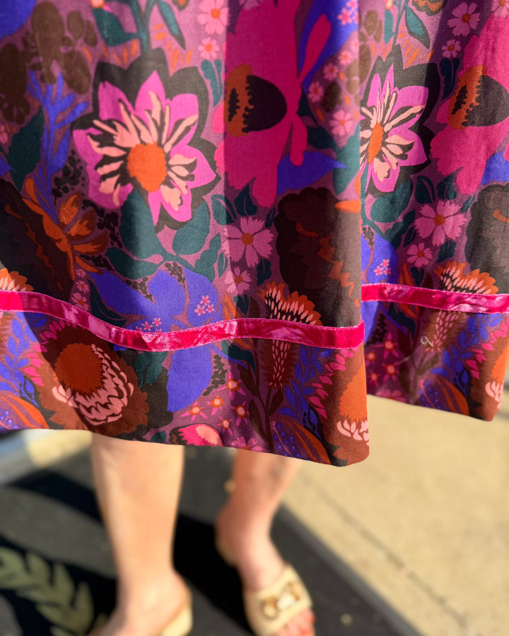 Shirred Floral Shift Dress with bold pink, purple, orange, and green floral pattern. Available in sizes XS–XL.