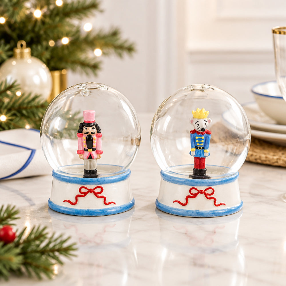 Nutcracker Salt & Pepper Shakers with clear glass snow globes on white bases, featuring a pink nutcracker and a mouse king.