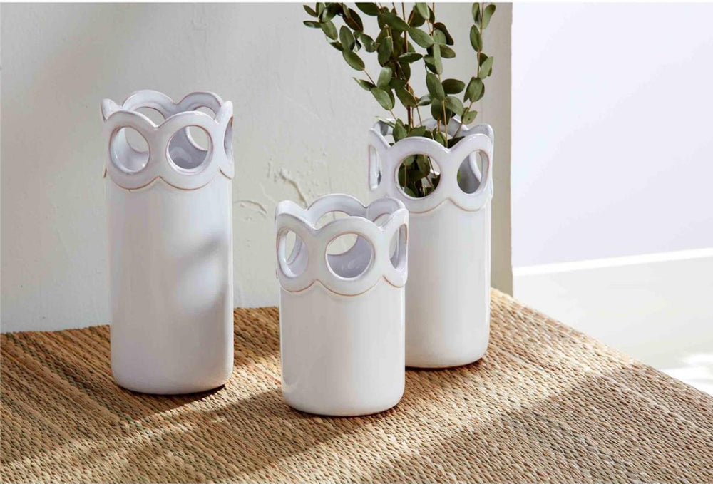 Set of three white ceramic scalloped bud vases, available in small, medium, and large sizes.