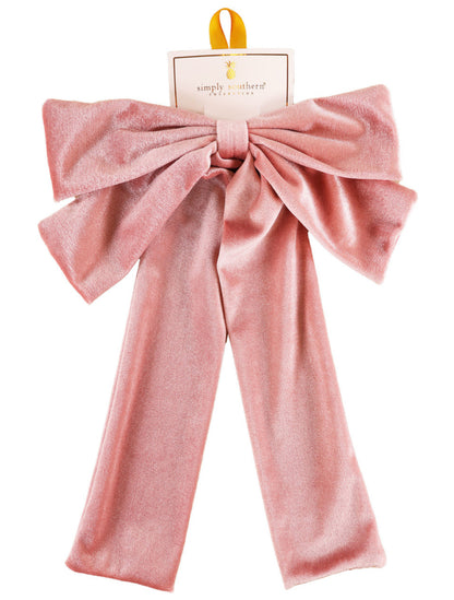 Large pink velvet bow hair accessory with long tails, yellow hanging loop, available in one size, Simply Southern label.