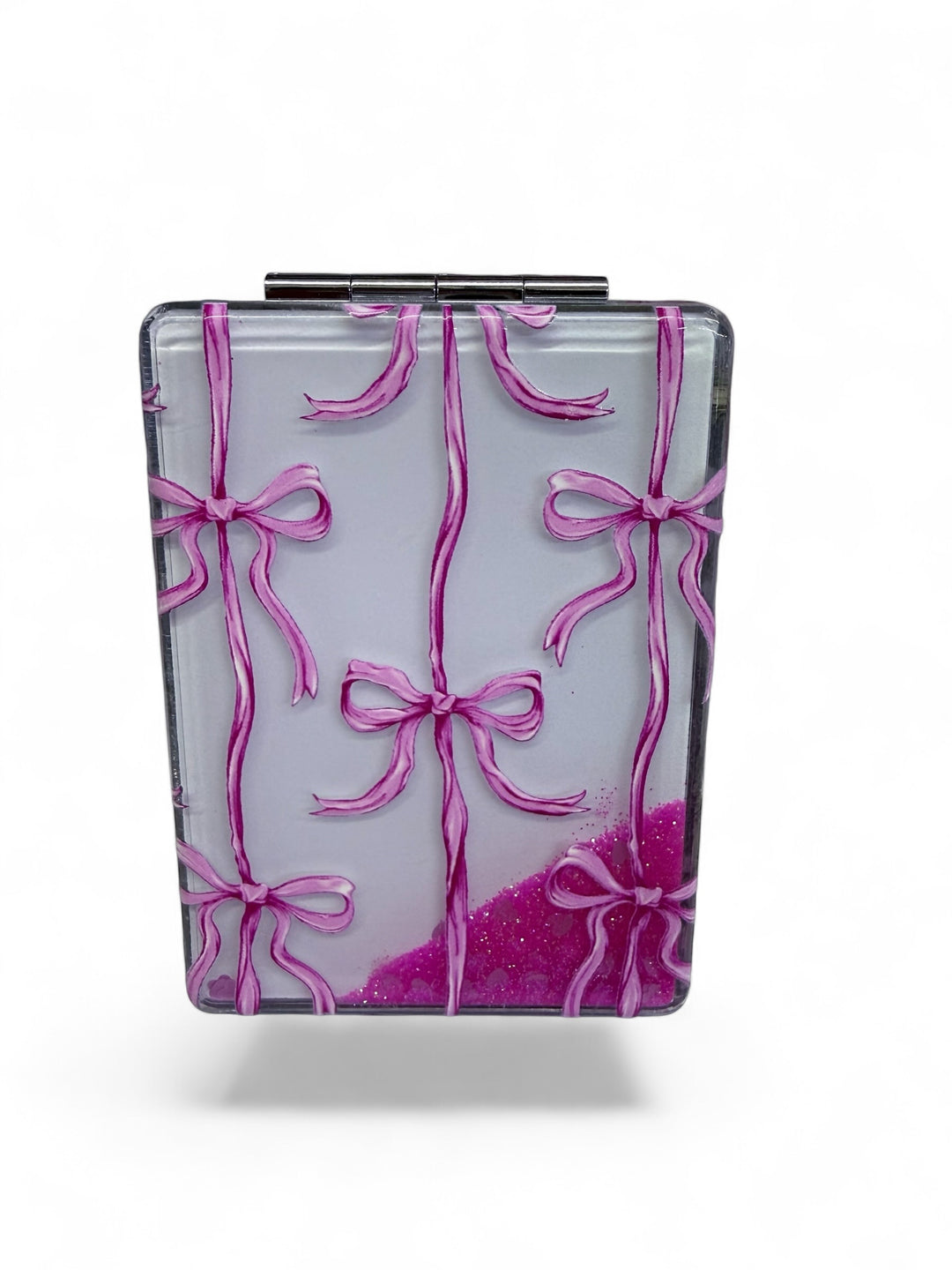 Rectangular compact mirror with silver frame, raised pink bows, pale background, and pink glitter accents. Sizes available.