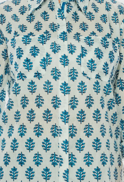 White cotton voile shirt with blue leaf pattern, two chest pockets. Available sizes: S, M, L, XL.