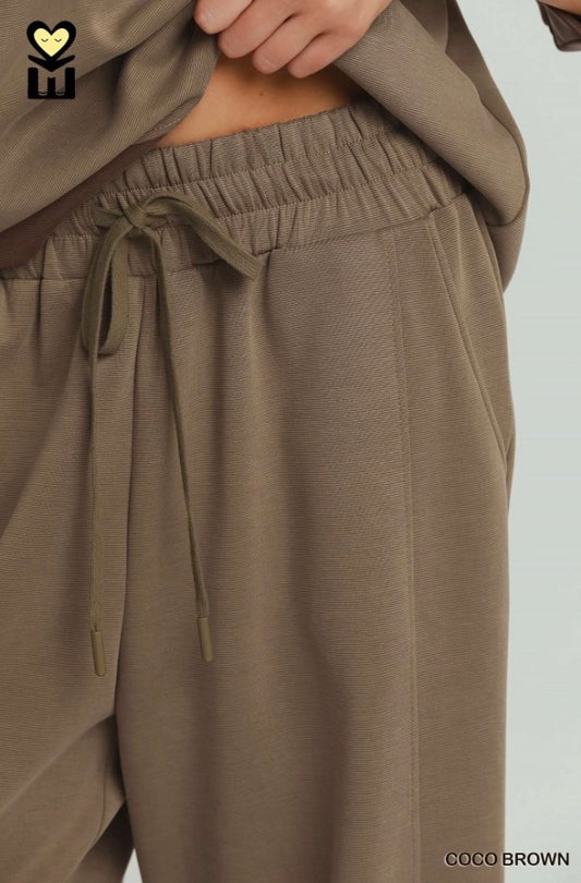 Loose-fitting, wide-leg Coco Brown Colorblock Straight Pants with visible waistband and drawstrings. Text "COCO BROWN" in bottom right corner. Available sizes: XS-XL.