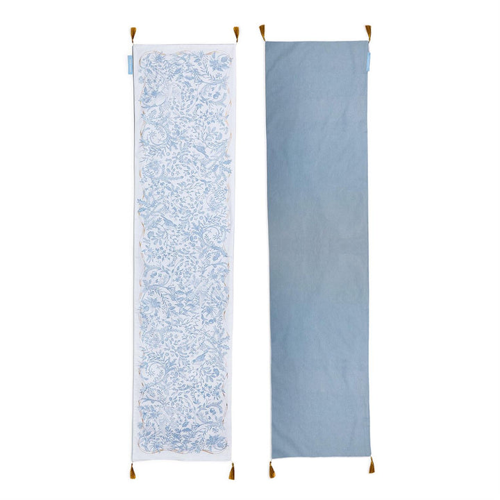 Gilded Cottage Double-Sided Table Runner with blue and white floral bird pattern, solid light blue reverse, and corner tassels. Available in multiple sizes.