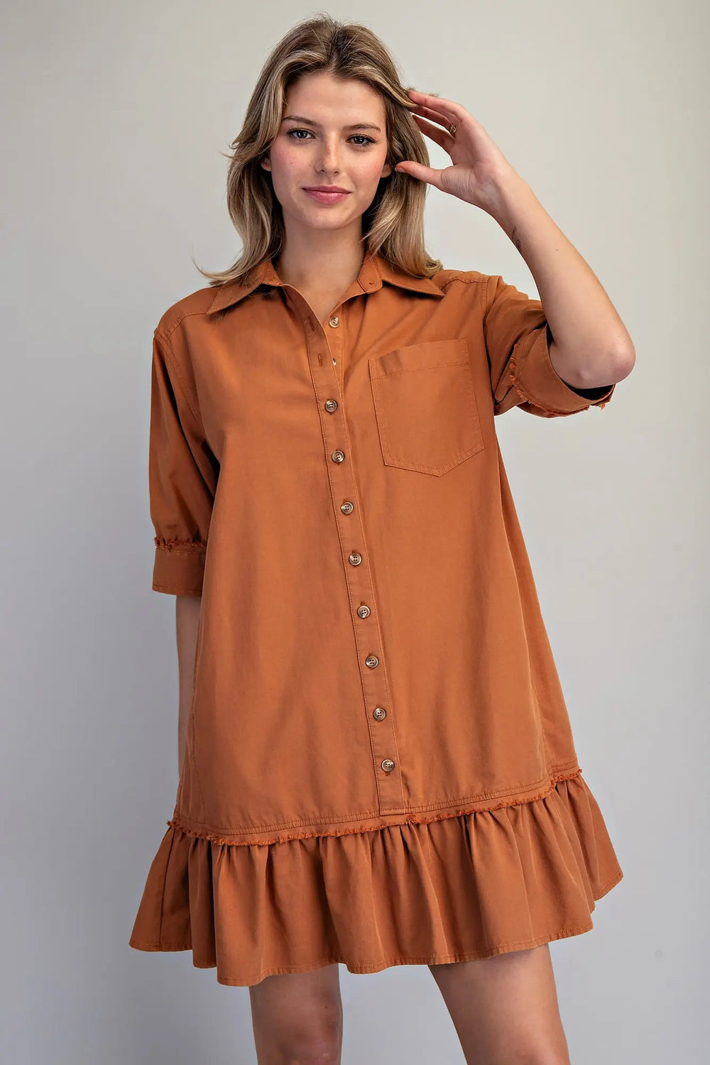 Clay Button Down Mini Dress in rust, short sleeves, chest pocket, button front, ruffled hem. Sizes: XS-XL.