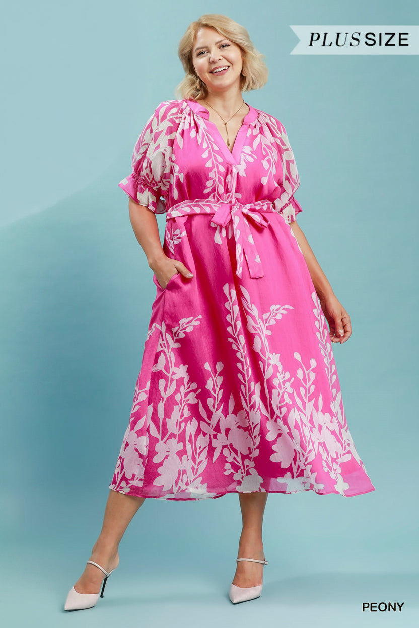 Pink Peony Midi Dress: pink and white floral midi dress with puff sleeves, split V-neckline, tie waist, and pockets. Available in sizes XS–XL.