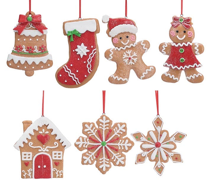 Seven hand-painted clay dough gingerbread ornaments in bell, stocking, gingerbread man, gingerbread girl, house, and snowflake shapes with red ribbon hangers.