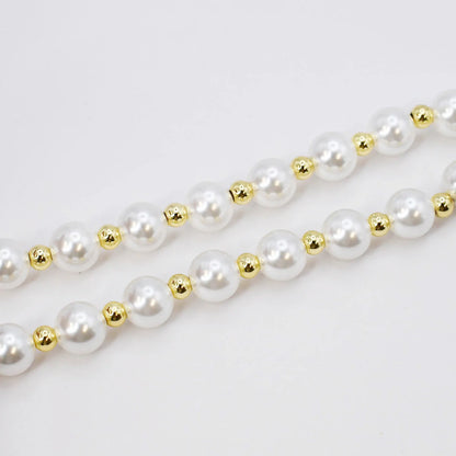 The Heart Pearl Necklace has two strands of white pearls with gold beads. Available in 16-inch and 18-inch sizes.