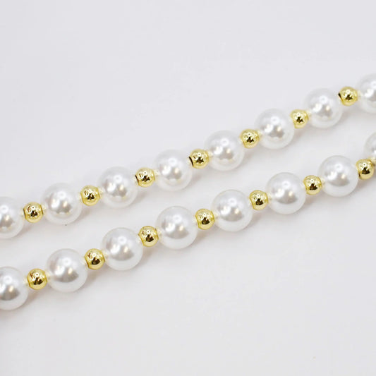 The Heart Pearl Necklace has two strands of white pearls with gold beads. Available in 16-inch and 18-inch sizes.