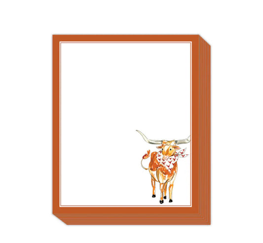 The Short Stack Pad: Bordered notepad with rust-colored edge; includes whimsical icon of a longhorn cow with red scarf in bottom right on a white background. Sizes available: Small, Medium, Large.