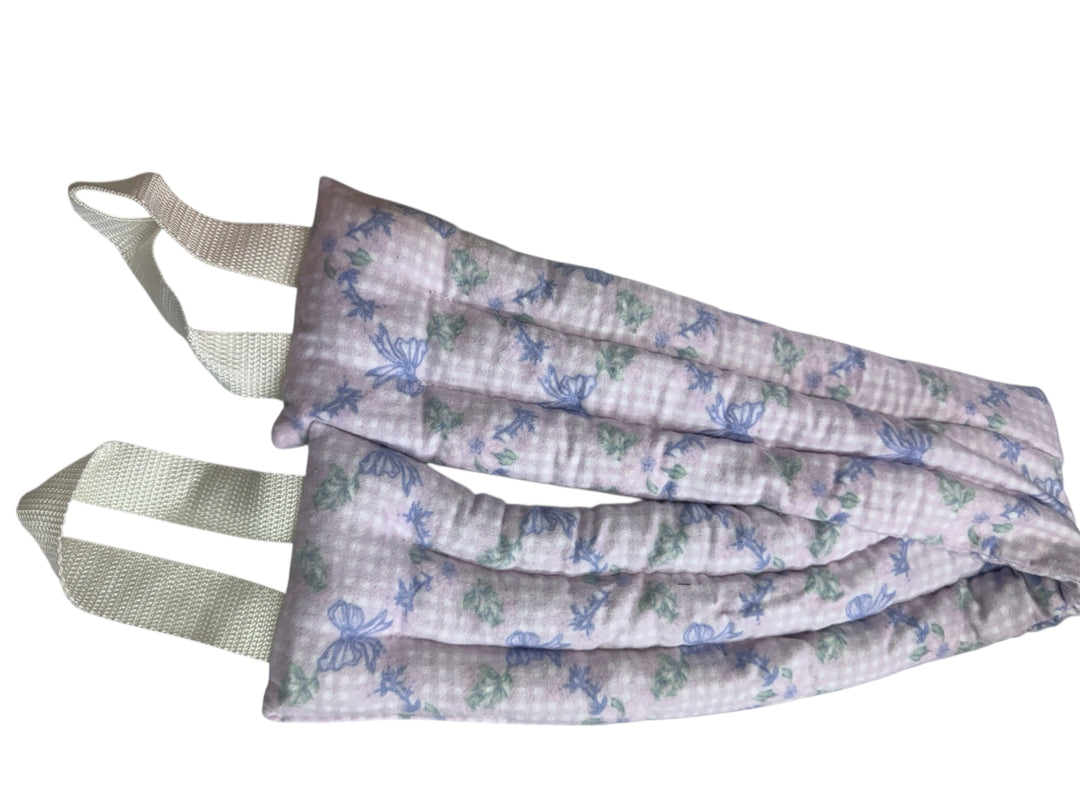 Soft rectangular neck wrap with pale purple floral pattern, two white handles; available in standard and large sizes.