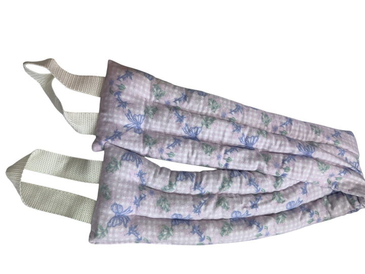 Soft rectangular neck wrap with pale purple floral pattern, two white handles; available in standard and large sizes.