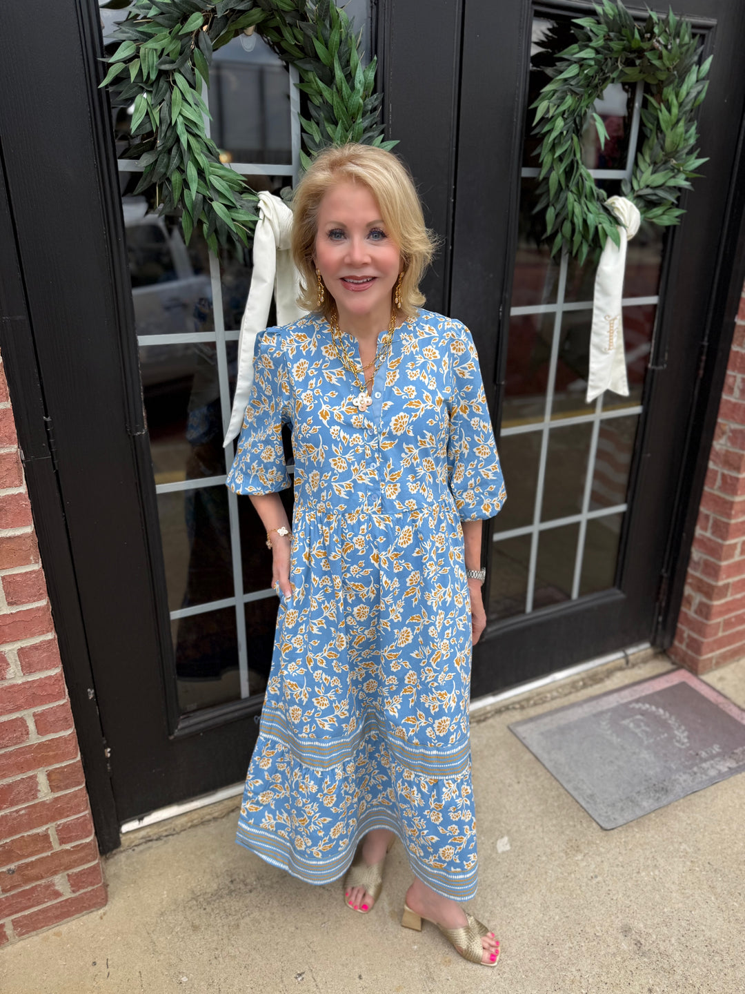 Riley Ivy Script Gold Dress: 3/4 sleeves, tiered midi skirt, blue and yellow florals. Available in sizes XS-XL.