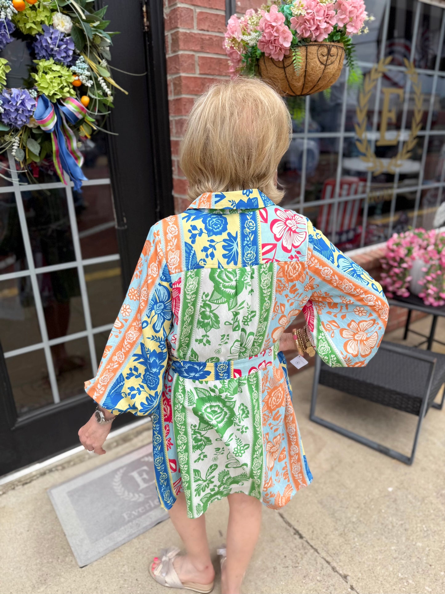 On Vacation Time Dress features blue, orange, green, and pink designs. Available in sizes XS-XL.