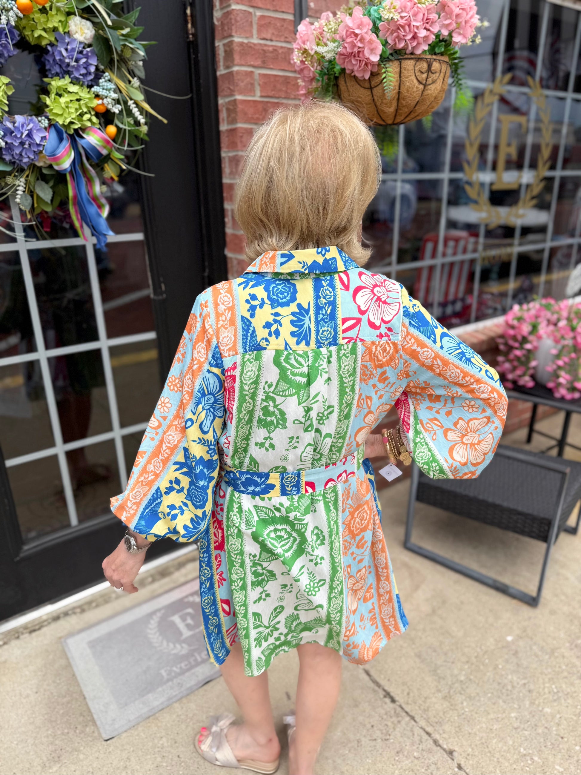 On Vacation Time Dress features blue, orange, green, and pink designs. Available in sizes XS-XL.