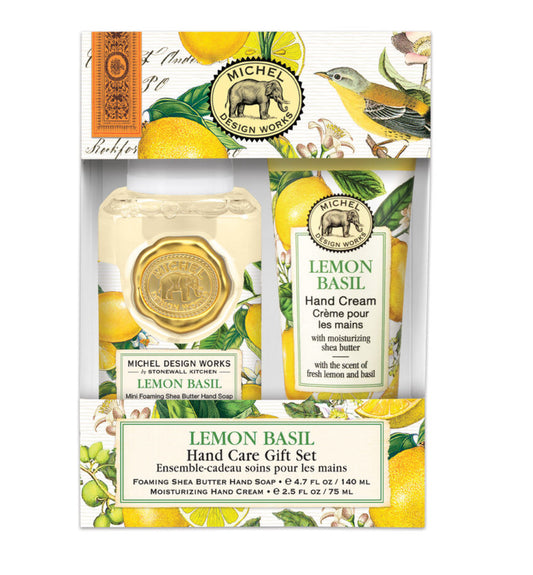 Lemon Basil Hand Care Gift Set by Michel Design Works. Includes foaming hand soap with shea butter and moisturizing hand cream. Fresh lemon basil scent. Packaging features yellow lemons, green leaves, intricate patterns. Sizes available: Standard gift set size only.